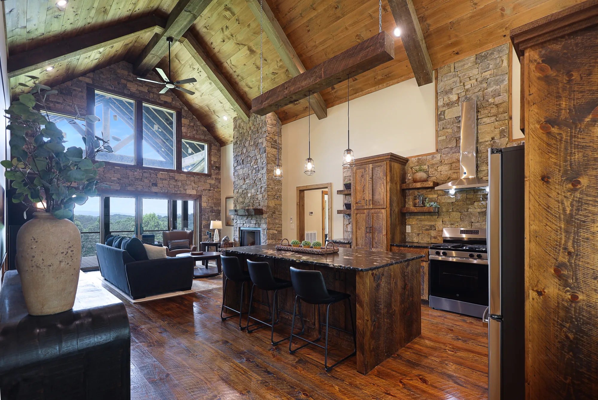 Great room — vaulted ceilings, stone fireplace