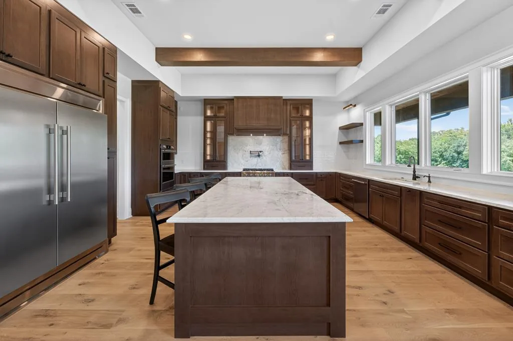 Kitchen — built-in refrigerator, marble island