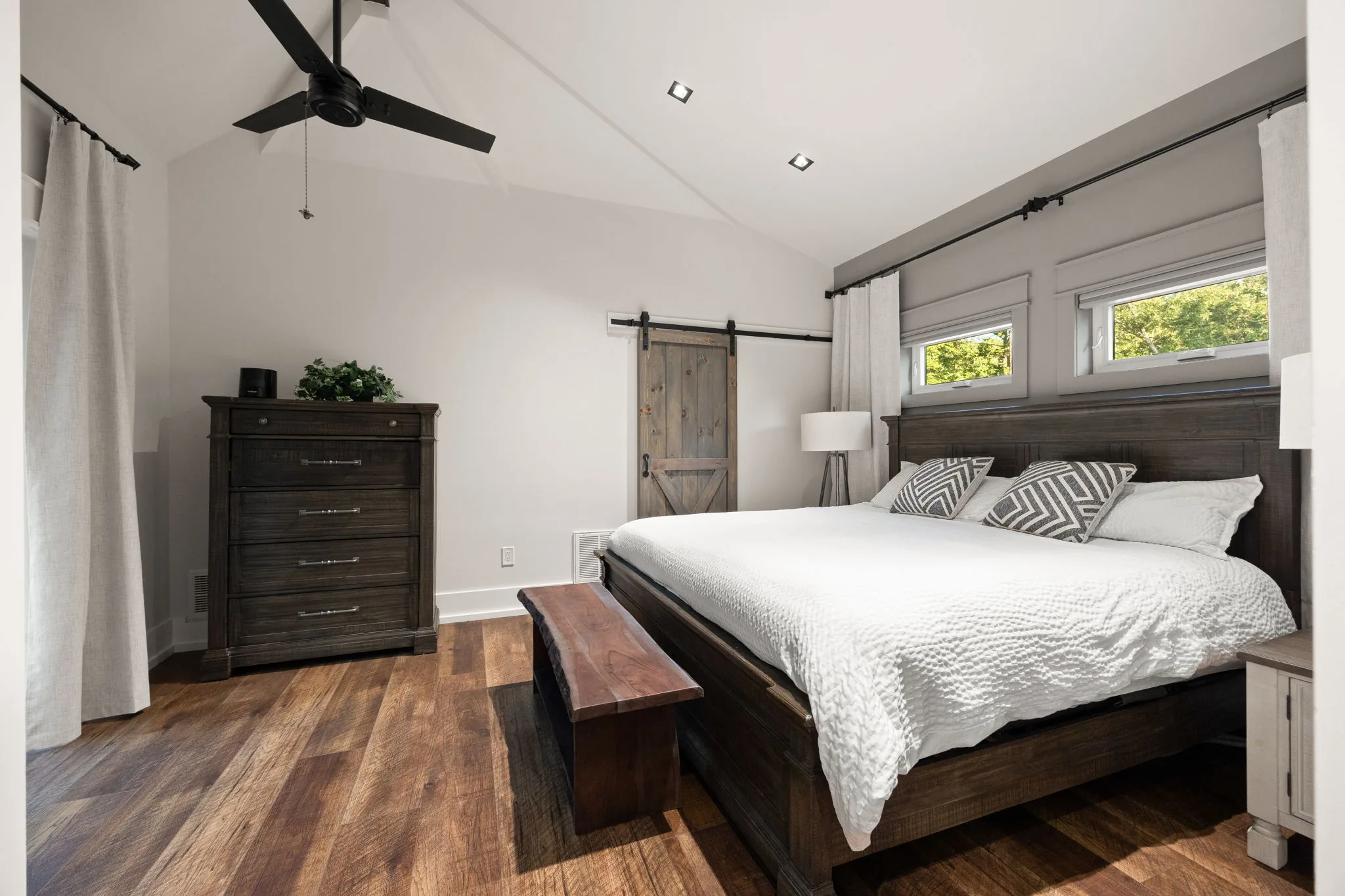 Second-floor bedroom wide: vaulted ceiling, covered beam, barn-door closet