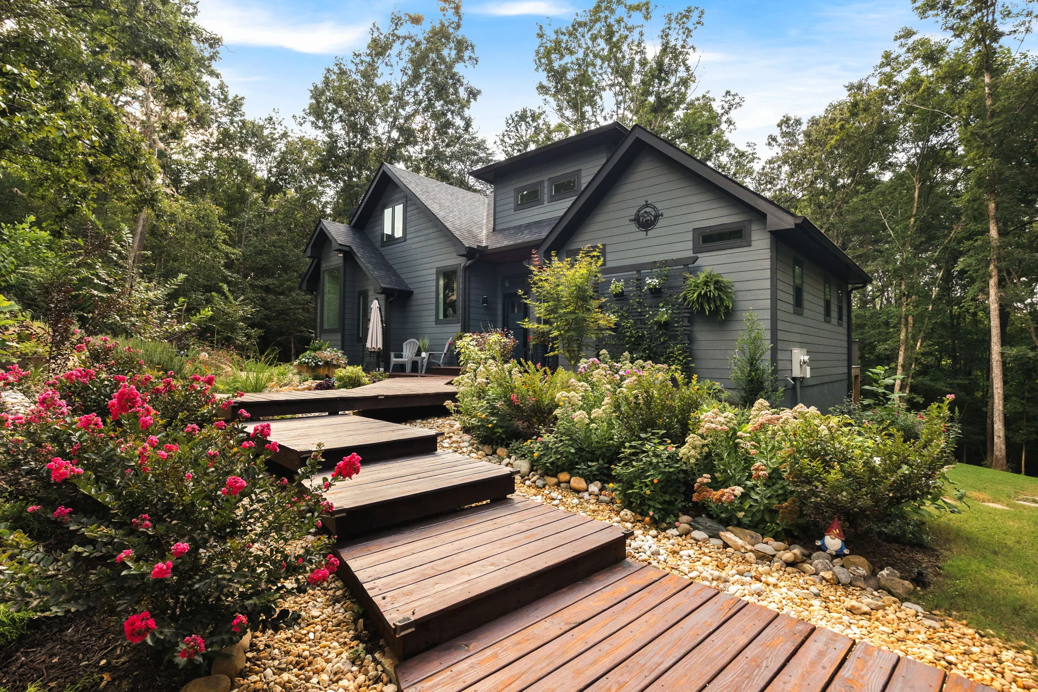 Front elevation with wood step treads and crepe myrtle leading up the front walk