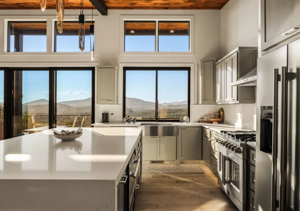 Kitchen island and pro-style range wall, framed by a panoramic mountain view