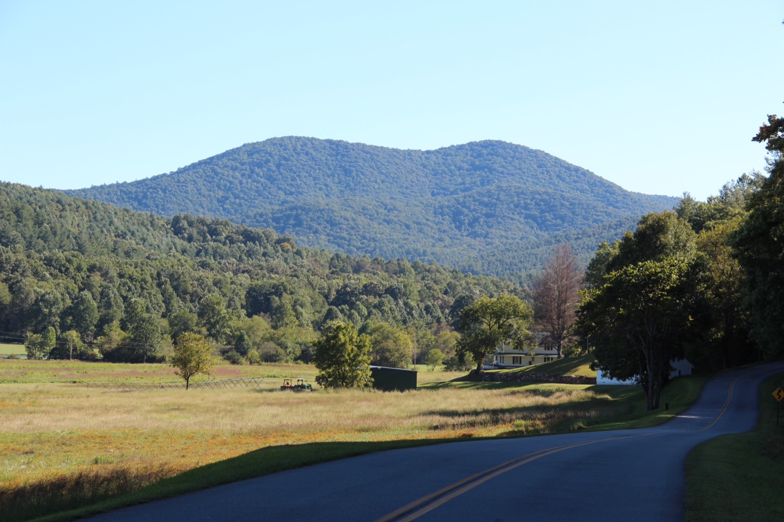 Big John Dick Mountain rising over a pasture and country road in Fannin County in the North Georgia mountains