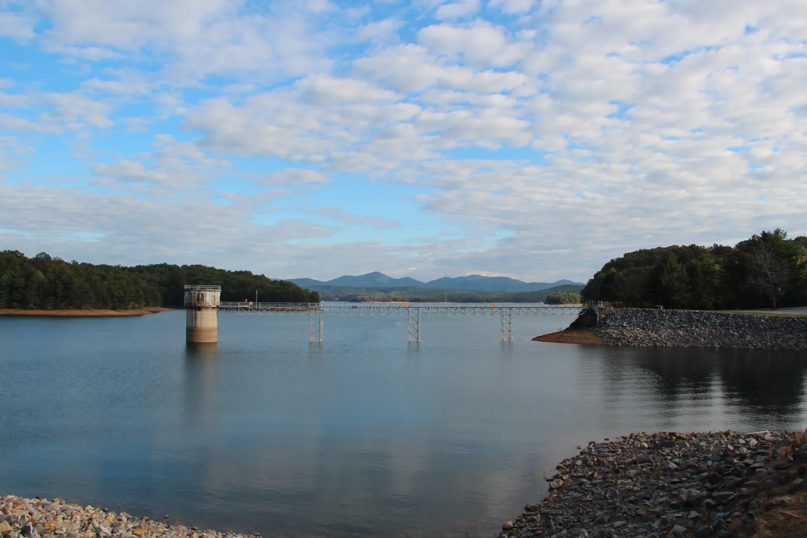 Lake Blue Ridge seen from Blue Ridge Dam, with the intake tower, walkway, and the North Georgia mountains behind the water