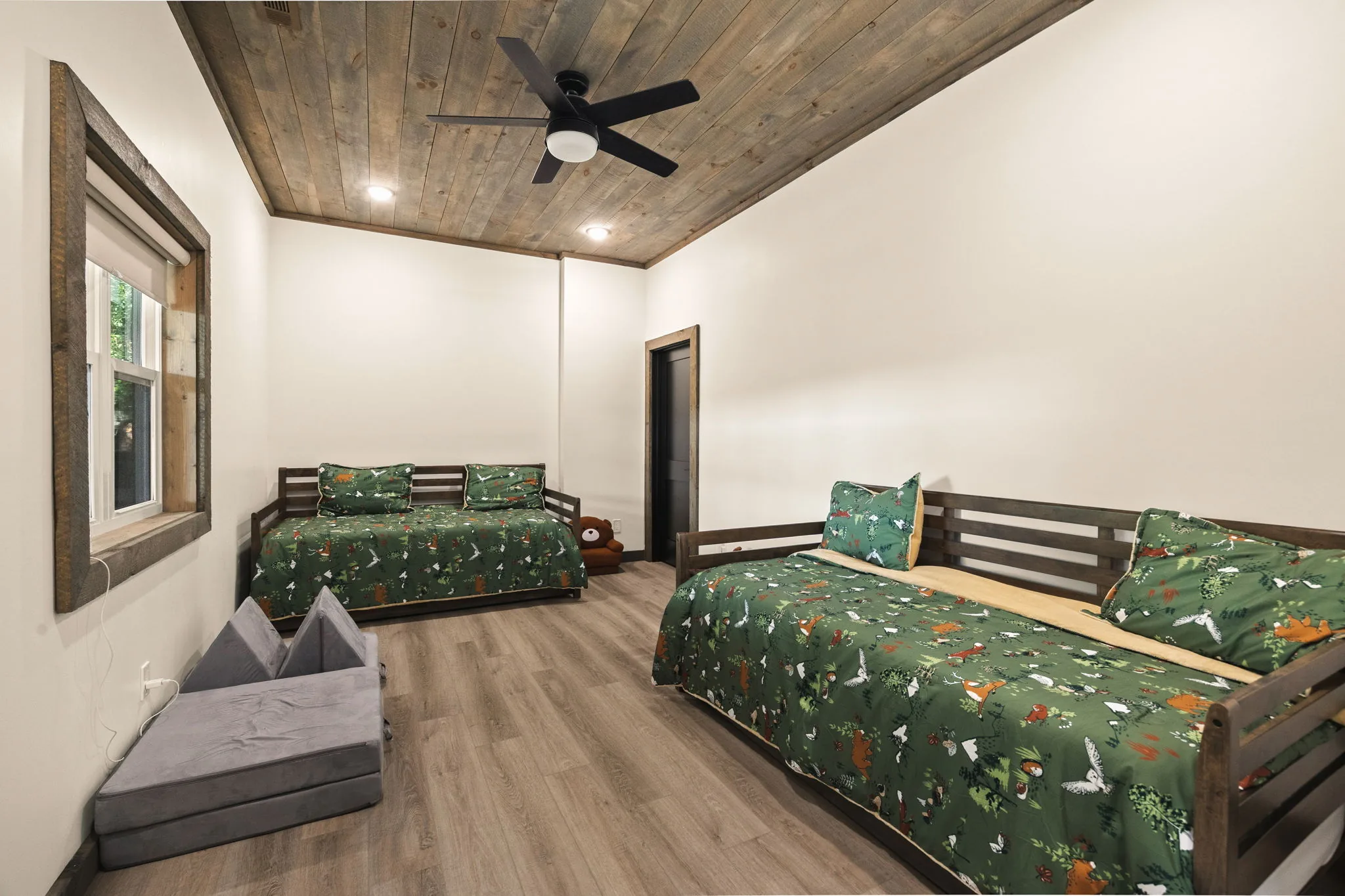Bunk room on the terrace level with two beds, made up for younger guests.