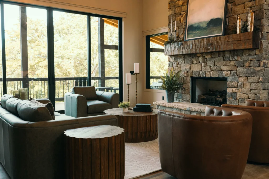 Great room of 44 Staurolite Mountain Road, Home #6 on the 2026 Parade, with a floor-to-ceiling stone fireplace and timber ceiling by Kevin Teague Homes